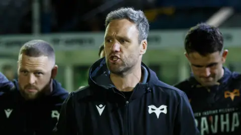 Ospreys head coach Mark Jones talks to his players