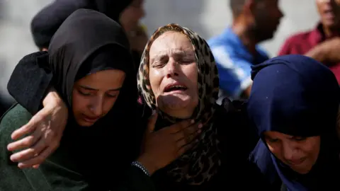 Mourners react during the funeral of Palestinians reportedly killed in an overnight Israeli strike on a tent in southern Gaza, at Nasser Hospital in Khan Younis (3 July 2025)