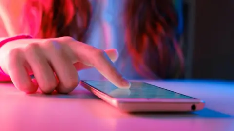 Getty Images Child scrolling on a mobile phone