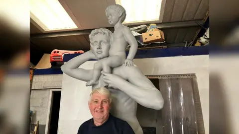 BBC Will Hennessy with the statue