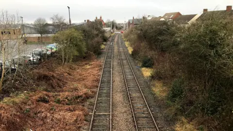 A railway with housing on one side and Coalville Market on the other