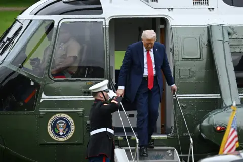 Leon Neal/PA Wire President Donald Trump emerges to walk down the steps of the helicopter at Chequers, the country home of the British prime minister in Aylesbury, England. 