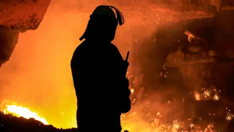A silhouette of a steel worker