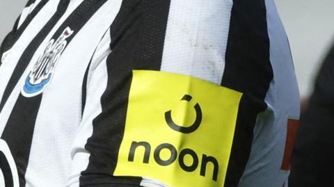 Noon's yellow logo on a Newcastle United shirt