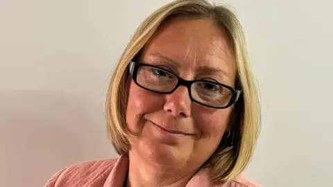 Supplied A head and shoulders image of a woman wearing glasses and looking into the camera.