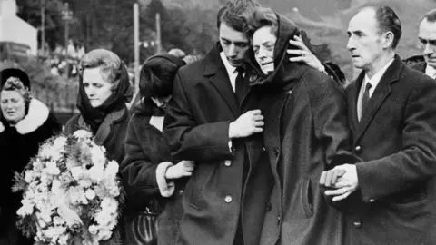 Getty Images One of the bereaved families at a mass funeral in Aberfan