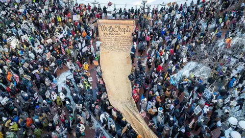 Getty Images Demonstrators march in Minnesota calling for an end to ICE operations