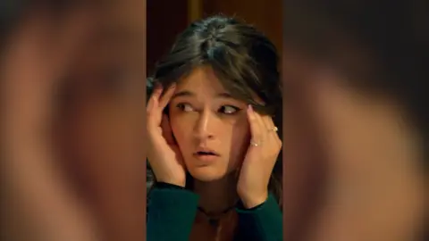 Traitors contestant Jade holding her head in her hands