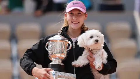 Mirra Andreeva with the French Open trophy and her dog