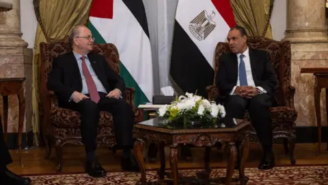 The Palestinian Prime Minister of the EPA, Mohammed Mustafa (L), speaks with the Egyptian Foreign Minister Badr Abdelatty (R) at the Al-Tahrir Palace in Cairo, Egypt (March 3, 2025)