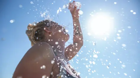 Getty images Woman pouring water on herself