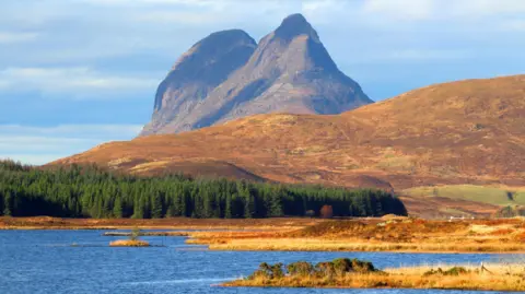 Getty Images The mountain has two humps like a camel. It has sheer sides and rises dramatically from a landscape of moorland, forestry and lochs.