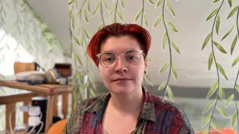 A University of Derby student, Rosie, sat in their student accommodation in Derby.