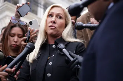 Getty Images Marjorie Taylor Greene speaks to reporters outside the US Capitol in March