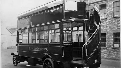Ipswich Transport Museum A black and white photo of an Eastern Counties bus in 1922. It shows an open top bus with stairs leading up to the top floor.
