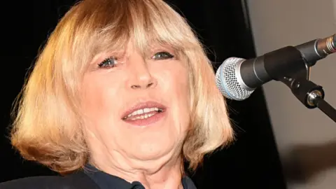 Getty Images Marianne Faithfull at a microphone in 2015