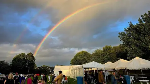 Stockton Heath Festival Festival tents in a field with people standing around