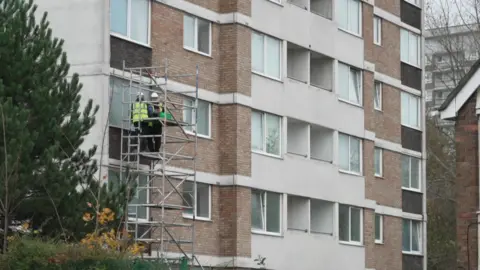 Workmen on the Roof are Pointing Windows on Windows on the lower floor