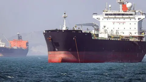 In this picture obtained from Iran's ISNA news agency and taken on May 2, 2026, the Gambia-flagged tanker vessel Bili is pictured anchored in the Strait of Hormuz off Bandar Abbas in southern Iran.