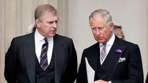 Getty Images Prince Andrew and the King in suits at St Paul's Cathedral in 2012 - They are both wearing suits with waistcoats, are leaning slightly towards each other, and appear to be having a serious conversation 