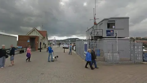 Image of Vincent's Pier in Scarborough, North Yorkshire with various people milling about 