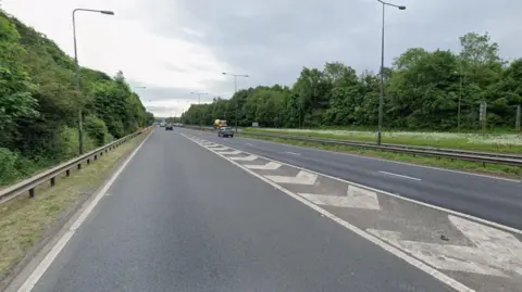 A Google street view image from a slip road onto a dual carriageway. Cars can be seen driving on either side