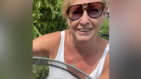Facebook A woman with blond hair and sunglasses smiles for the camera