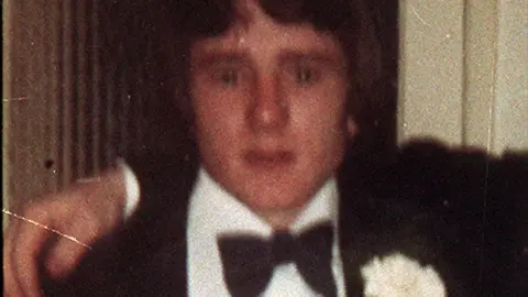 Pacemaker A colour archive picture showing Brian McKinney. He has medium length dark hair covering his forehead and ears. He is wearing a tuxedo with a bowtie and a flower on his breast pocket with another person having their arm around his shoulders.