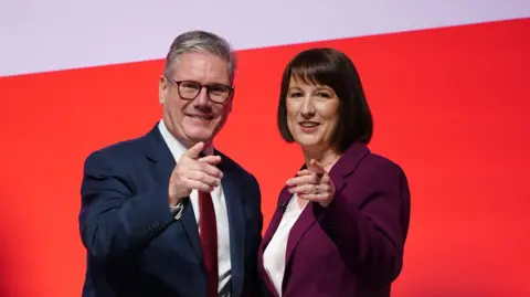 PA Media Sir Keir Starmer and Rachel Reeves on stage at Labour conference after the chancellor delivered her speech to the hall