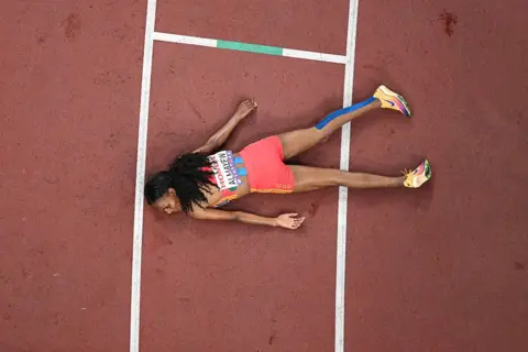 ANTONIN THUILLIER / AFP A woman lie face down on a race track.