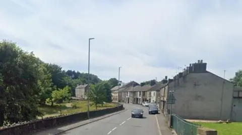 Google A Google Street View screenshot of the houses at Hall Park View in Workington, which is a row of terraced houses along Hall Brow and opposite Hall Park.