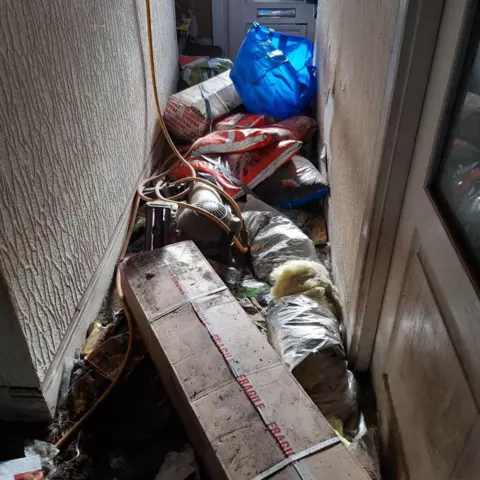 SSPCA The hallway of a home filled with rubbish
