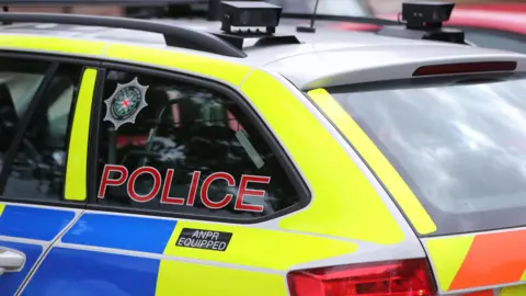 A PSNI car that is blue and yellow, it says police in red letters and anpr equipped