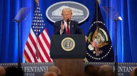 Getty Images Donald Trump speaks at the Department of Justice last week. He pledged to fight gang violence and step up deportations.