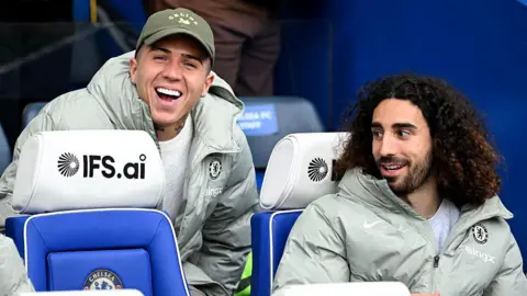 Enzo Fernandez joking with Marc Cucurella on Chelsea's bench
