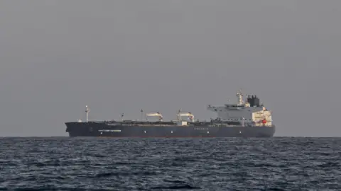 The Anatoly Kolodkin oil tanker, a black and white large vessel, is seen in the ocean from the port of Matanzas