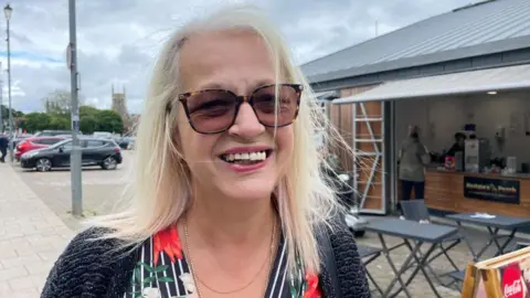 Andrew Turner/BBC Michelle Docwra standing near Great Yarmouth Market
