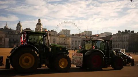 Jordan Pettitt/PA Two tractors on a road in central London with the London Eye in the background