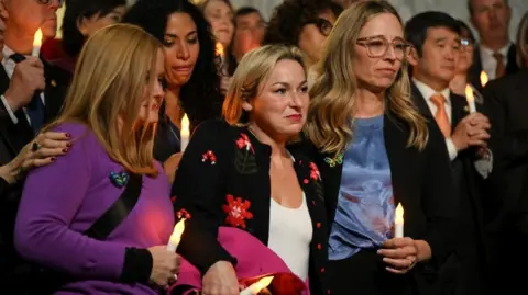 Jeffrey Epstein survivors Danielle Bensky and Liz Stein hold electric candles as they react to the Senate's passing of the bill to force the release of files related to the late convicted sex offender Jeffrey Epstein, on Capitol Hill in Washington DC.