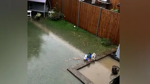 A garden - lawn and patio - submerged under water