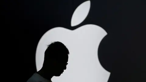 Reuters A man's shadow is seen in front of the Apple logo