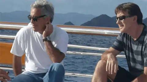 US Department of Justice Jeffrey Epstein and Peter Mandelson wearing sunglasses as they sit on a yacht.