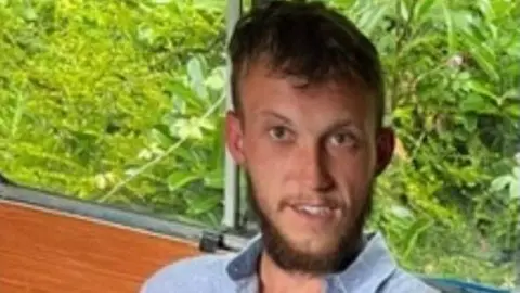 Family handout A man with a blue shirt and short hair and a beard