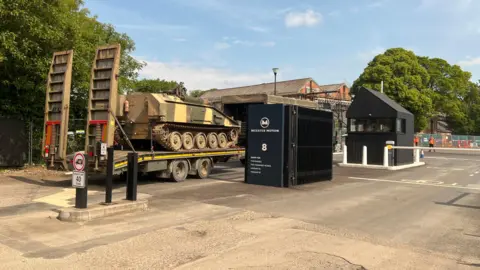 A view of Bicester Motion from Gate 8. There is a carrier vehicle passing through. 