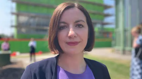 BBC/Charlotte Wright Bridget Phillipson, wearing a purple top and blue jacket, looks into the camera on a bright sunny day.
