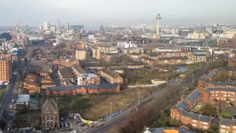 An aerial shot of land close to Liverpool's Chinatown. A triangular piece of land screened off by hoardings can be seen running along the length of Great George Street. 