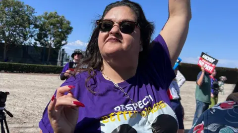 Cynthia “Cyn” Carranza protests with other Disneyland employees outside the park