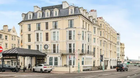An exterior shot of the front of Queens Hotel on Brighton seafront