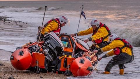 The Cromer RNLI crew dragging the lifeboat into the water