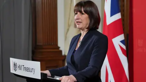 Getty Images Chancellor Rachel Reeves standing at a lectern with a HM Treasury sign on the front